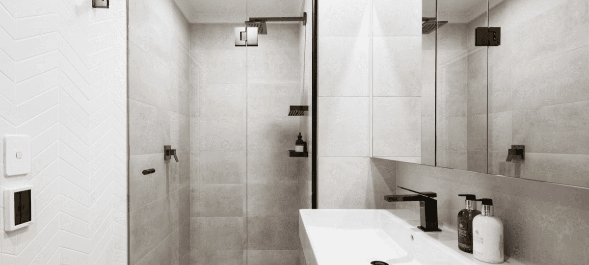 bathroom renovation grey tiles black tapware