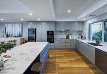 renovated kitchen, new flooring and layout with large kitchen island, built-in appliances, stone sops and splashback, contemporary and luxurious.