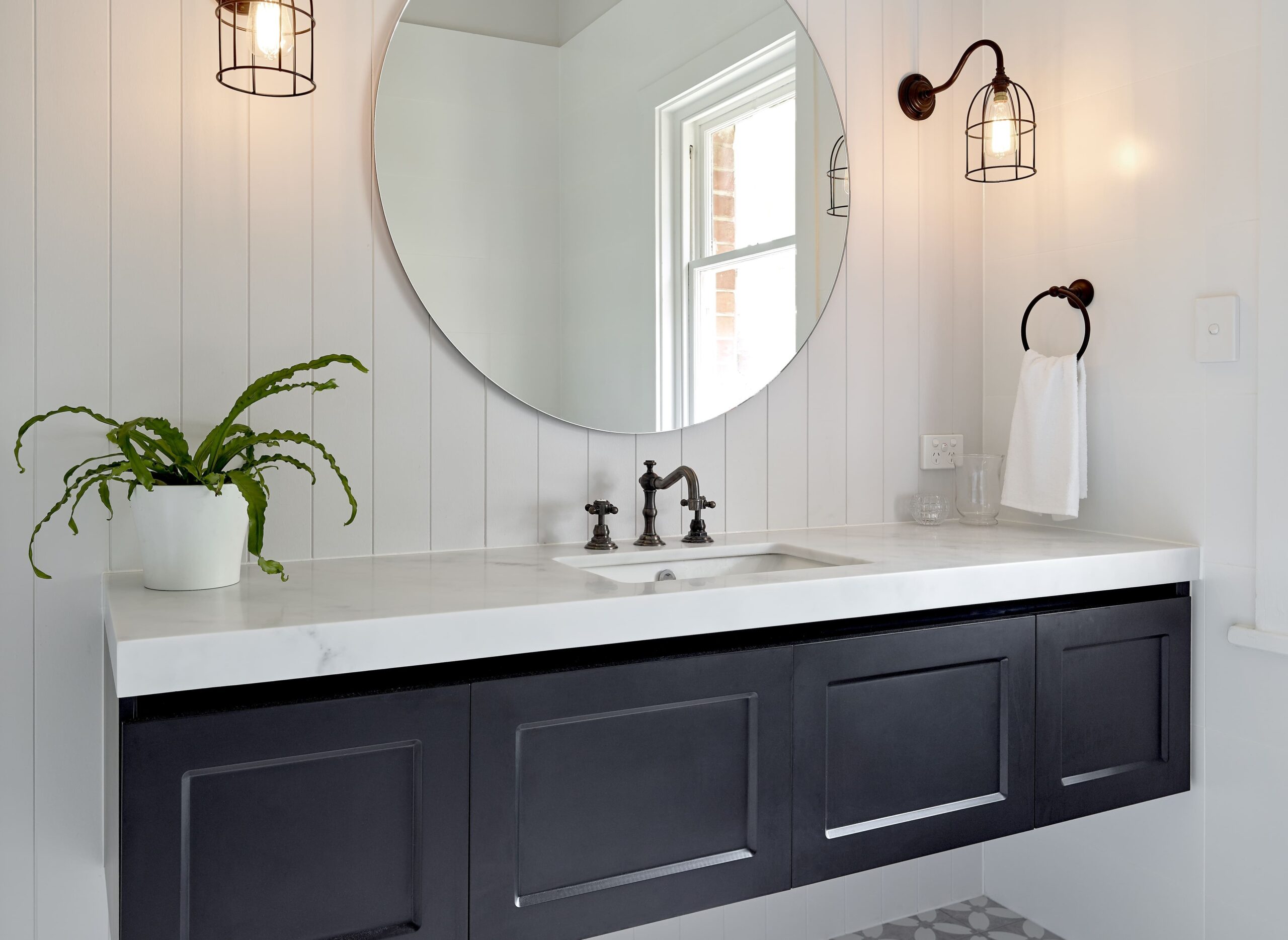 Hamptons Style Bathroom with V-Jay Panelling, Shaker Cabinet Vanity in Black with Carrera Benchtop, a Frameless Mirror and Oil-Rubbed Black Accessories