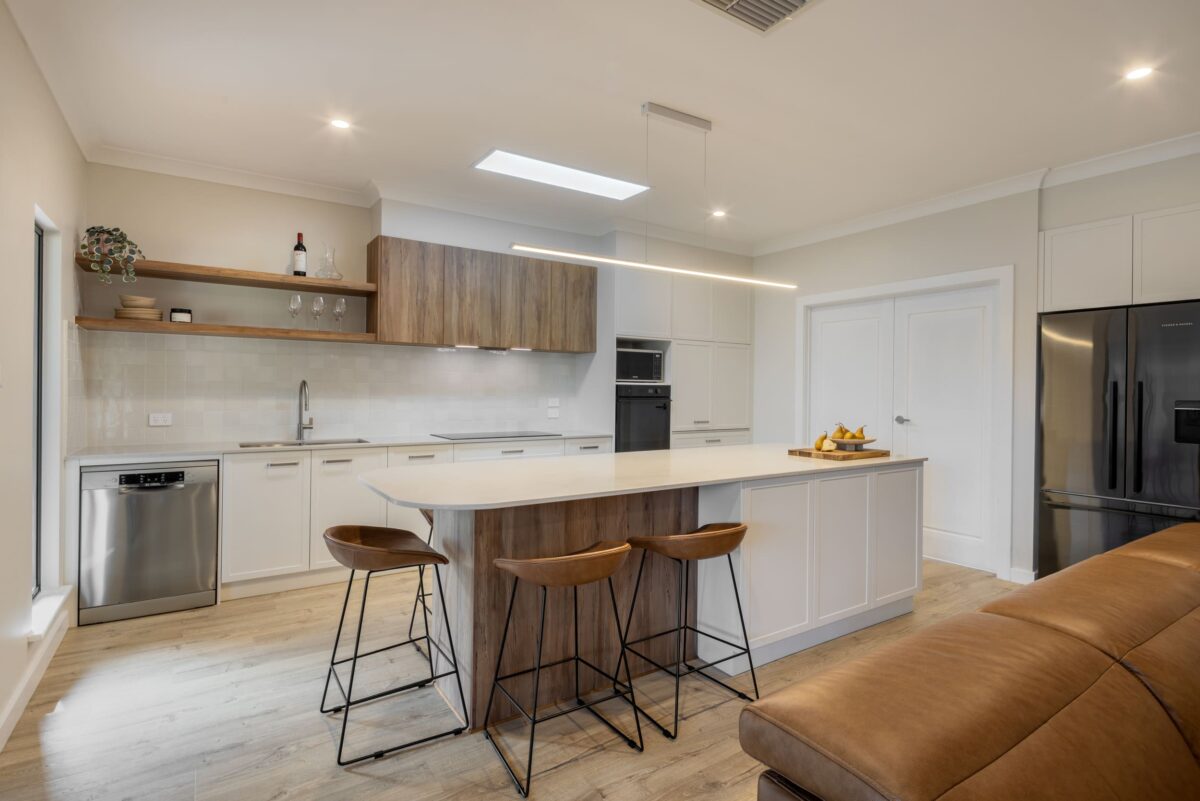 renovated kitchen and living areas, open plan design with bespoke joinery, kitchen island with functional storage, ceiling skylight and new appliances.