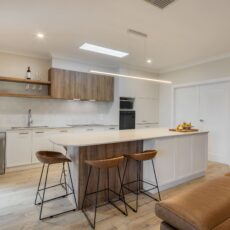 renovated kitchen and living areas, open plan design with bespoke joinery, kitchen island with functional storage, ceiling skylight and new appliances.