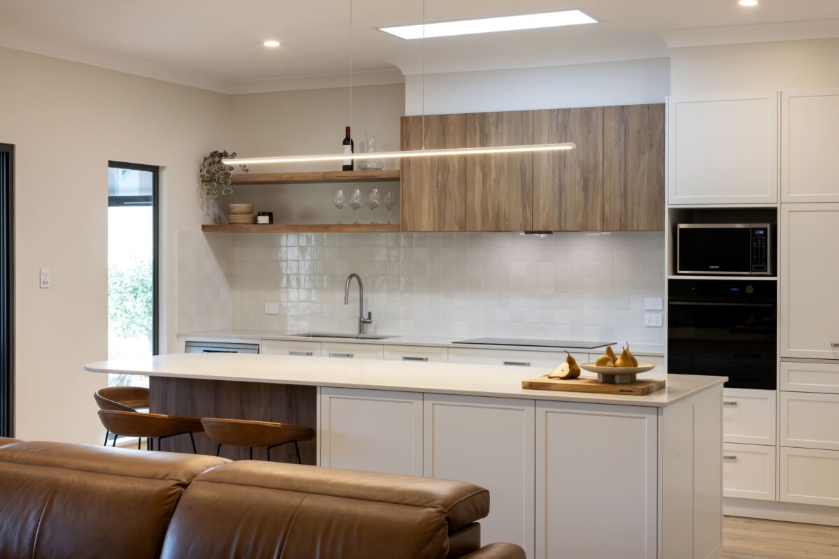 renovated kitchen and living areas, open plan design with bespoke joinery, kitchen island with functional storage, ceiling skylight and new appliances.