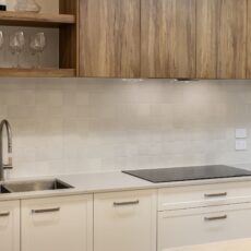 Kitchen renovation in Paradise SA featuring small square tiled splashback, engineered benchtops, double-bowl sink and bespoke joinery in timber and white tones