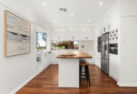 renovated kitchen, contemporary - country style, new kitchen island in solid timber benchtop in a Wormy Chestnut finish; bespoke joinery in white paired with black handles; extend the original 1990s Brushbox parquetry flooring into the kitchen area.