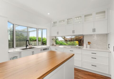 renovated kitchen, contemporary - country style, new kitchen island in solid timber benchtop in a Wormy Chestnut finish; bespoke joinery in white paired with black handles; extend the original 1990s Brushbox parquetry flooring into the kitchen area.