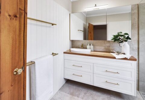 renovated bathroom, country style with VJ panelling, brushed brass tapware, solid timber benchtop, floating vanity and mirror cabinet