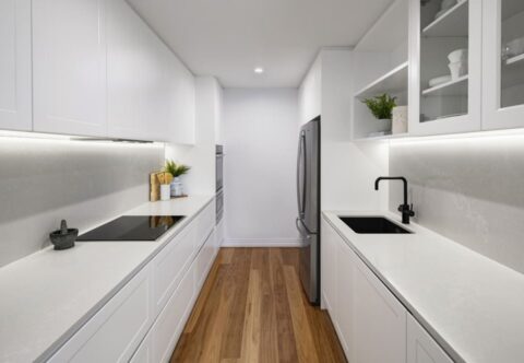 renovated kitchen, bespoke joinery, new appliances, stone benchtops and splashback, black tapware, contemporary style, white shaker doors and glazed doors