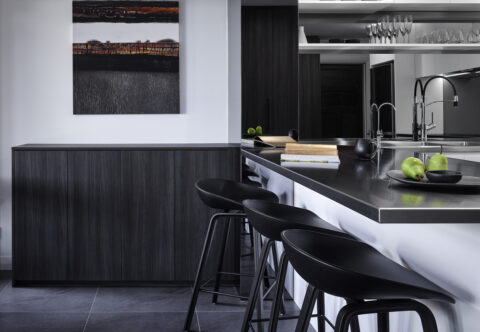 renovated kitchen, stainless steel benchtops and mirror splashback, breakfast bar, bespoke joinery with built-in appliances