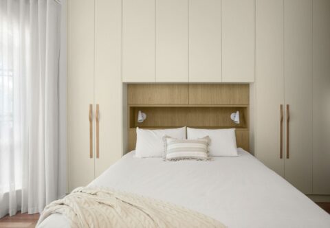 Renovated master suite and wardrobe, contemporary style with custom cabinetry, in porcelain and oak tones.