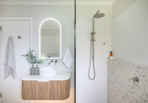 renovated bathroom with terrazzo floor tiles and feature kitkat tiles, LED mirror cabinet and walk-in shower