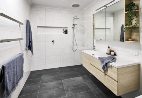 renovated bathroom, floating vanity, large mirror shaving cabinet with end open shelves, generous walk-in shower with shower niche.
