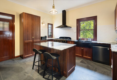renovated kitchen, large format floor tiles, stone benchtops, Falcon cooker, and bespoke joinery in solid wood