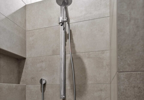 renovated bathroom, shower alcove with shower niche with underfloor heating, floor-to-ceiling tiles