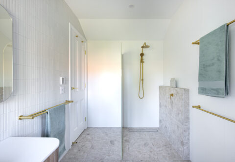 renovated bathroom, open shower, brushed brass tapware, white matt mosaic feature wall, shower ledge, underfloor heating
