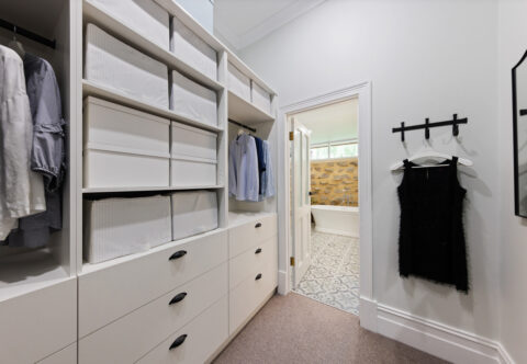 renovated walk-in robe, new carpet, open shelves and drawers, black handles, functional and bright