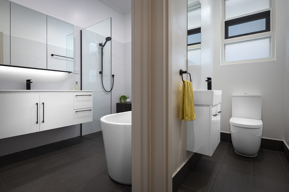 renovated bathroom and WC, the WC has compact basin and the adjacent bathroom a large vanity, mirror cabinets and open walk-in shower.