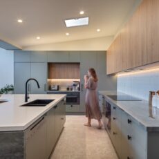 renovated kitchen, contemporary style, beautiful green cabinetry paired with Tasmanian oak and Emerald Green natural Quartzite benchtops and black fixtures and fittings