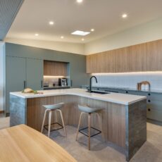 renovated kitchen, contemporary style, beautiful green cabinetry paired with Tasmanian oak and Emerald Green natural Quartzite benchtops and black fixtures and fittings