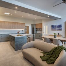 renovated kitchen, and living room of 1920s California Bungalow, beautiful green cabinetry paired with Tasmanian oak and Emerald Green natural Quartzite and black fixtures and fittings