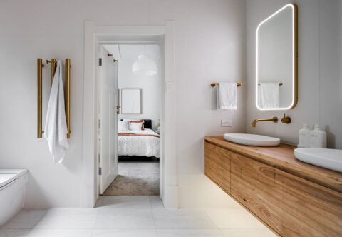 renovated bathroom, award winning design, solid wood vanity and brushed gold tapware