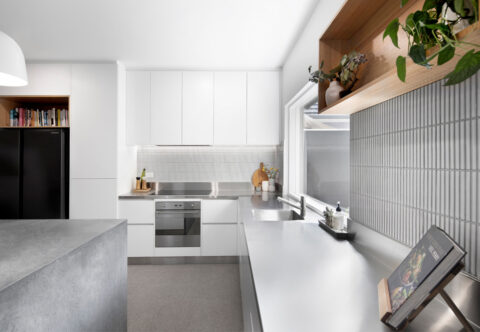 renovated kitchen for a professional chef, stainless-steel benchtops, Scandinavian style, open shelves and white joinery