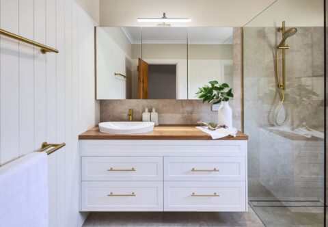 renovated bathroom, country style with VJ panelling, brushed brass tapware, solid timber benchtop, floating vanity and mirror cabinet