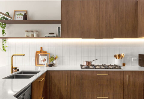 renovated kitchen, contemporary style with bespoke cabinetry in walnut tones paired with brushed brass tapware.