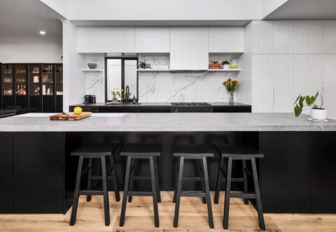 renovated kitchen, black and white joinery, minimalistic design, with Dekton benchtops and splashback, hybrid timber flooring, large kitchen island with breakfast bar.