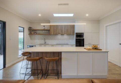 renovated kitchen and living areas, open plan design with bespoke joinery, kitchen island with functional storage, ceiling skylight and new appliances.