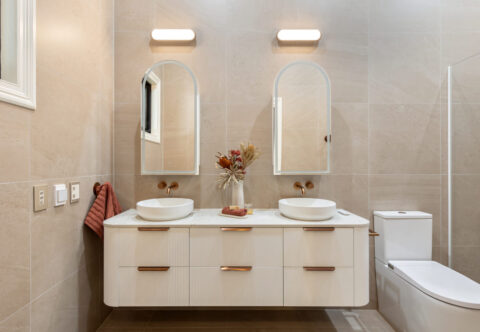 renovated bathroom, sophisticated design, warm tones, wall-hanging double vanity with twin mirrors