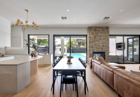 renovated living, dining and kitchen areas, contemporary, large black framed windows and doors, new wooden floor, open plan design