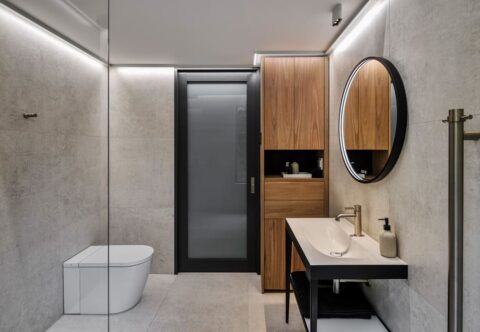Renovated bathroom, contemporary style, with full length wall ceramic slabs, smart toilet and custom cabinetry