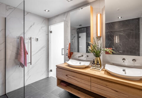 renovated bathroom, luxurious style, custom made timber vanity in Australian Chestnut, twin mirrors, and large format tiles