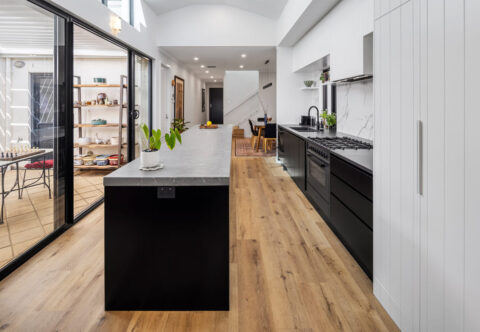 renovated kitchen, monochromatic, minimalistic design, with Dekton benchtops and splashback, hybrid timber flooring, skylight and open plan layout.