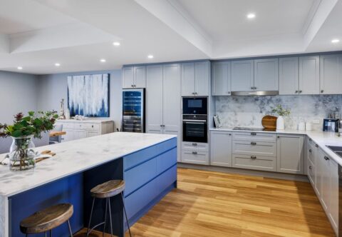 renovated kitchen, new flooring and layout with large kitchen island, built-in appliances, stone sops and splashback, contemporary and luxurious.