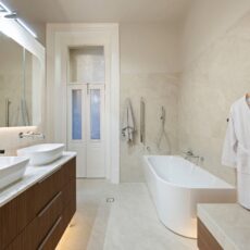 Renovated bathroom in Glenelg, with a double basin vanity, shaving cabinets, corner bathtub and plenty of storage.