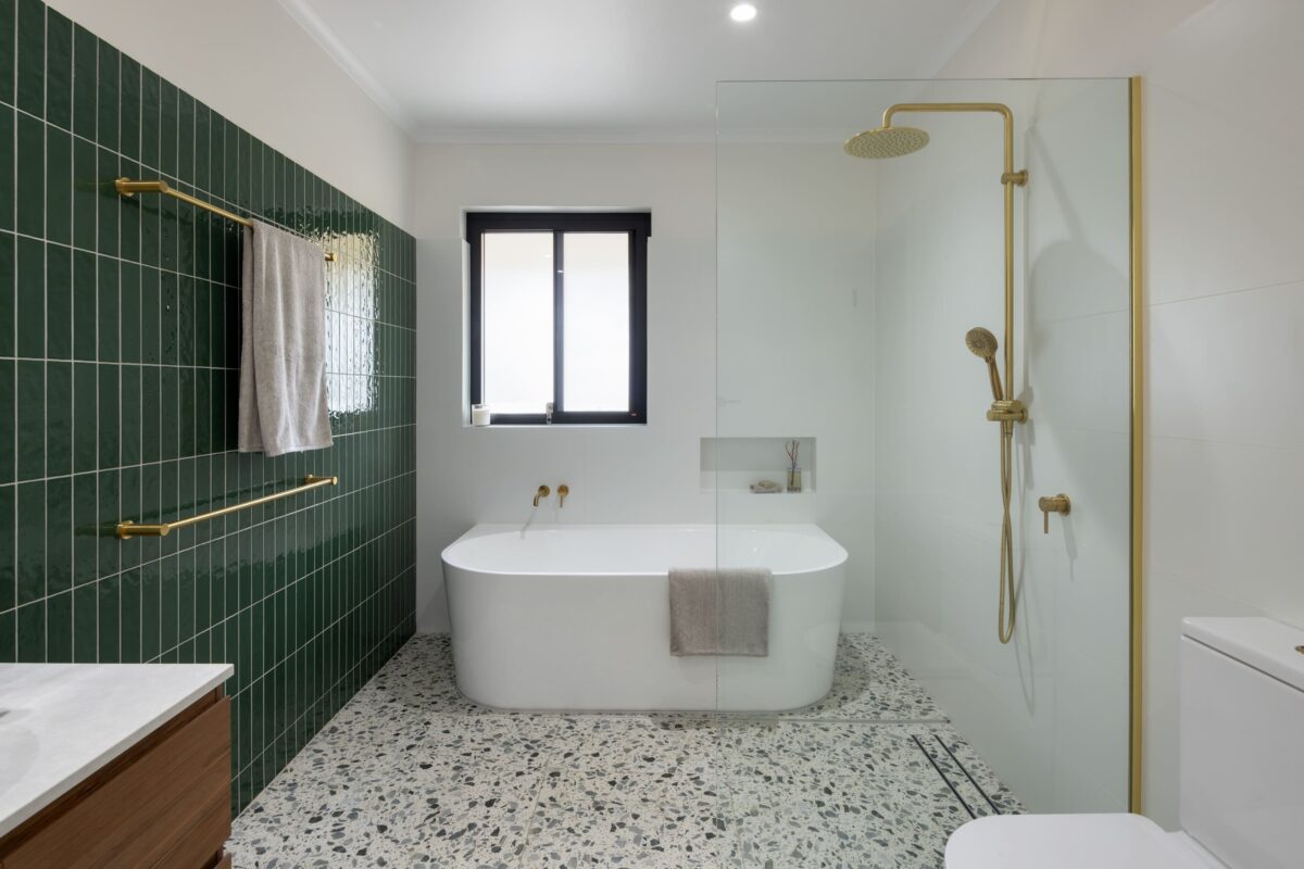 Renovated family bathroom with spacious back to wall bathtub, walk-in shower and wall niche