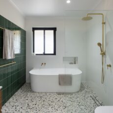 Renovated family bathroom with spacious back to wall bathtub, walk-in shower and wall niche